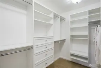 Custom walk in closet with shelving and drawers.