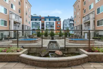 Here is the inner courtyard- accessible from 2nd floor- complete with outdoor shower, 2 jacuzzies, BBQ, water feature and lounge/dining/sunbathing areas