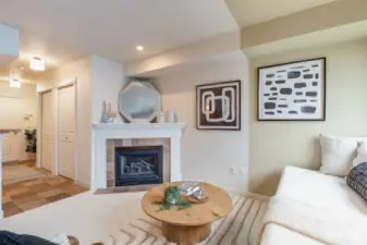 Another view of living room, this one showing the wide entry way and gas fireplace