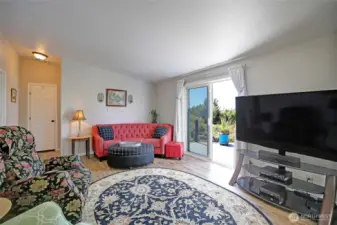 Living room with easy access to the deck & sunset views.