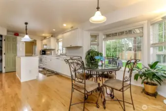 Center-of-the-home eat-in kitchen that radiates warmth and welcome, wrapped in abundant natural light from large windows that set the mood for every meal and gathering, from casual breakfasts to festive entertaining.