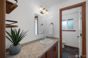 Upstairs main bathroom with sinks in main area and water closet.