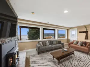 View of family room from left side of fireplace looking towards windows & entrance just right of the garage.