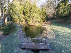 A spring-fed pond is at the back of the rear yard. A quaint bridge leads to another section of the rear yard offering even more play and entertaining space.