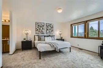 Primary bedroom with views windows and a private bath.