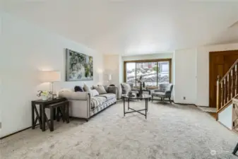 Formal living room with a large picture window that frames the scenery and lets in the natural light.