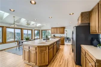 The expansive kitchen is the heart of the home and is open to the casual dining area with a wall of windows and skylights to take full advantage of the views and natural light.