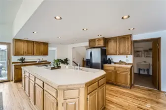 Stainless steel appliances and an oversized island equipped with a sink and range/oven adds to the appeal of this kitchen.