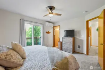 Another view of primary bedroom with slider to private deck