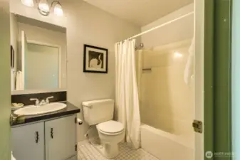 Guest bath with tub convenient to living/dining and  secondary bedroom.
