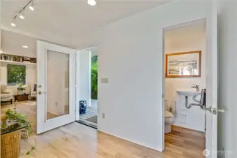 One of two entrances, this beautiful glass door lets in beautiful light. A half bathroom on the main level, perfect for guests.