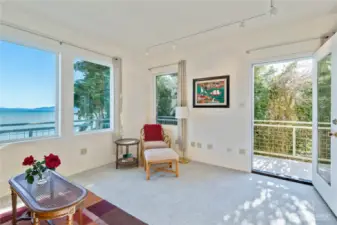 The secoond bedroom upstairs also has beauitful views as seen through large windows and deck access.