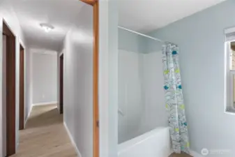 Full bathroom upstairs at the end of the hallway. 2 bedrooms to the left and laundry room to the right.