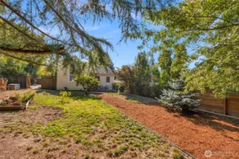 The front yard is spacious and can support garden beds or ample space to add a workshop or other detached structure
