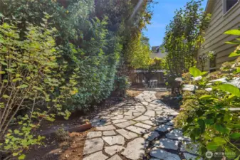 A beautiful yard area, includes a stone path and patio area perfect for relaxing outdoors.The large backyard or front yard is ideal for summer gatherings, pets, or play space.