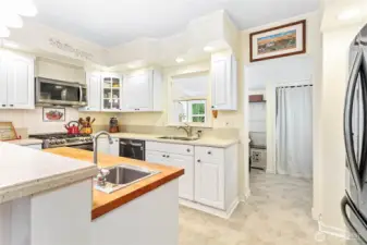 Spacious mud/laundry room w/access to back of home, pantry closet & utility sink