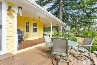 Porch wraps around from front entry to this larger deck off sunroom