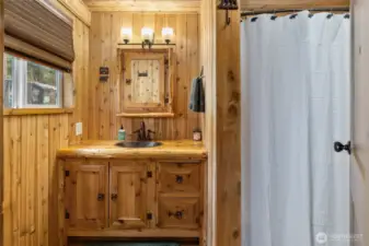 Main floor bathroom with tub and shower