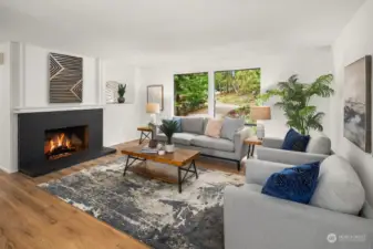 The living room of this home has a wood burning Fireplace and large windows to the front yard.  There are new luxury Plank Floors through out the home.