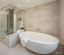 Take it all in...the custom tilework, the huge soaking tub and the chic vibe of the room. What you can't see ... heated floors to wake up to when you need it the most!