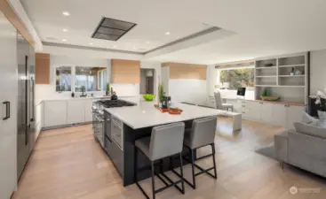 Amazing cabinetry adorn this epicurean's kitchen. check out the custom built in desk space in the background.