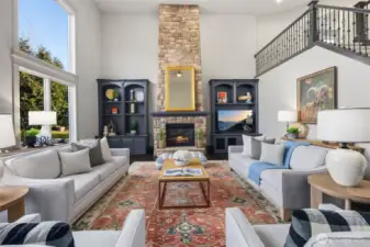 WOW! The Impressive Family Room With 2-Story Ceiling Is Designed For Both Grandeur And Comfort. Built-In Custom Shelving Surrounds The Stone Fireplace.