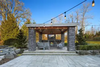 The Breathtaking $400,000 Recent Heated Outdoor Living Space Addition Is An Entertainer’s Dream Featuring A Wood-Burning Fireplace, 2 Heaters & TV.