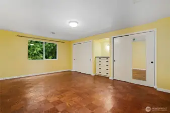 Upper level second Bedroom with hardwood floors and custom built-ins