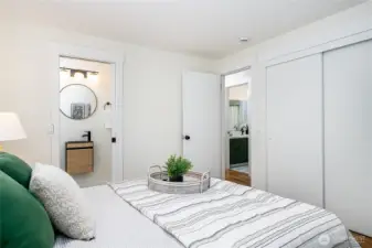 Primary bedroom with en-suite ¾ bath, shown here looking toward the hallway. The guest bathroom is just across the hall to the right.