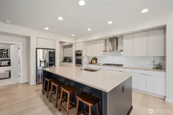 Oversized Island in your chefs dream kitchen with quartz counters and luxury appliances.