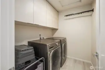 Upstairs laundry with beautiful shelving and built in drying racks.