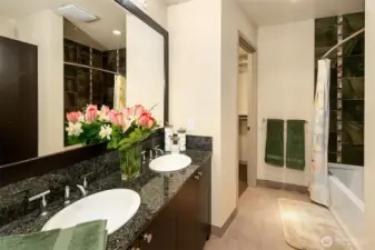 Primary bath has dual vanity, deep soaking tub.