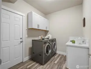 The laundry toom is conveniently located at the entrance to the garage.