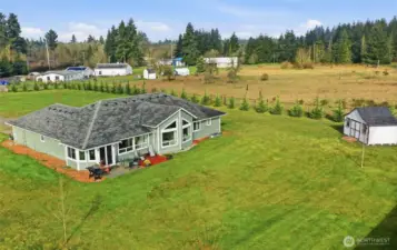 Gorgeous windows frame the territorial and mountain view Eastward, with quality storage and cedar tree-lined property edge seen here.