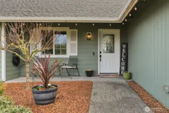 Lovely beveled glass front door also allows light in to the entry; window trim and shutters are another quality detail.