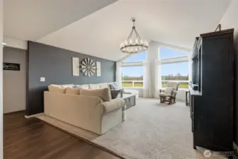 Vaulted living room highlights the view with these stunning windows facing east toward Mt Rainier.