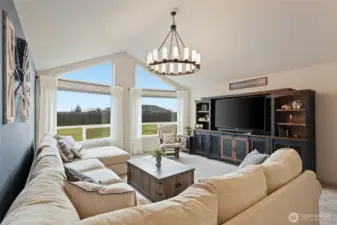 Plush carpet and dramatic light fixture add to this absolutely gorgeous space.