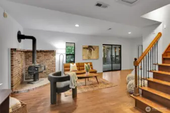 The wood-burning stove creates a cozy gathering place during cooler months.