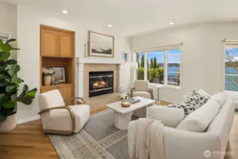 The focal point of relaxation, featuring a classic gas fireplace and vast windows that frame the entertainment deck and Lake Washington.