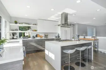 Chef’s kitchen comes complete with a new Thermador range, dishwasher, waterfall island, and custom walk-in pantry