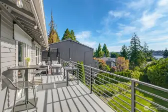 Multiple outdoor entertaining spaces with deck and wraparound patio