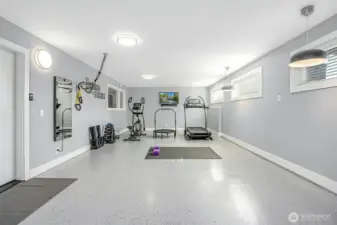 Attached heated flex space with epoxy floor currently housing in-home gym but can accommodate 2-cars tandem for a collector car showcase or ???