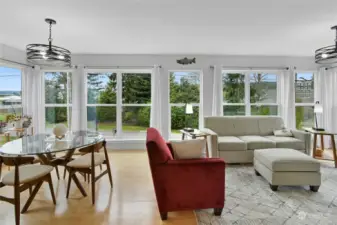 Living room and dining areas have a wall of windows to let in the natural light and views.