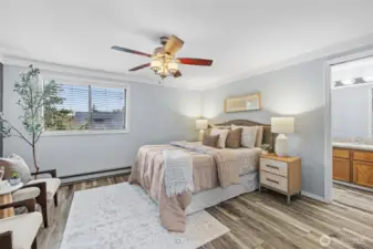 Primary Bedroom has a ceiling fan, engineered hardwood floors and ensuite bathroom and walk in closet.