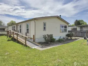 Welcome to this small (only 18 homes) 55+ park. This is the end unit with a nice back yard area and ramp for easy access.