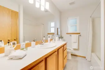 The hall bathroom is located between the second and third bedrooms.
