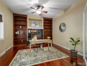 Beautiful wood floors, built-in cabinets, French doors & gas fireplace make this office/den comfortable and cozy.  Would also make a lovely music room, library/reading room or additional sitting room to entertain guests.