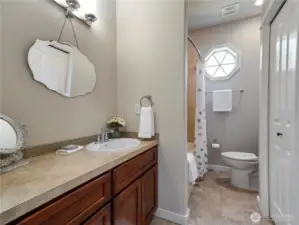 The vanity has an extended counter, bath/shower, linen closet, and a walk-in closet with built-in closet system.