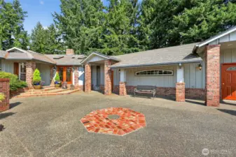 A lush, landscaped front entry courtyard provides a serene welcome to the home.”