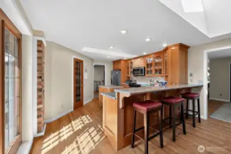 The large kitchen offers oak cabinetry, granite countertops, a roomy pantry, and a breakfast bar for casual dining